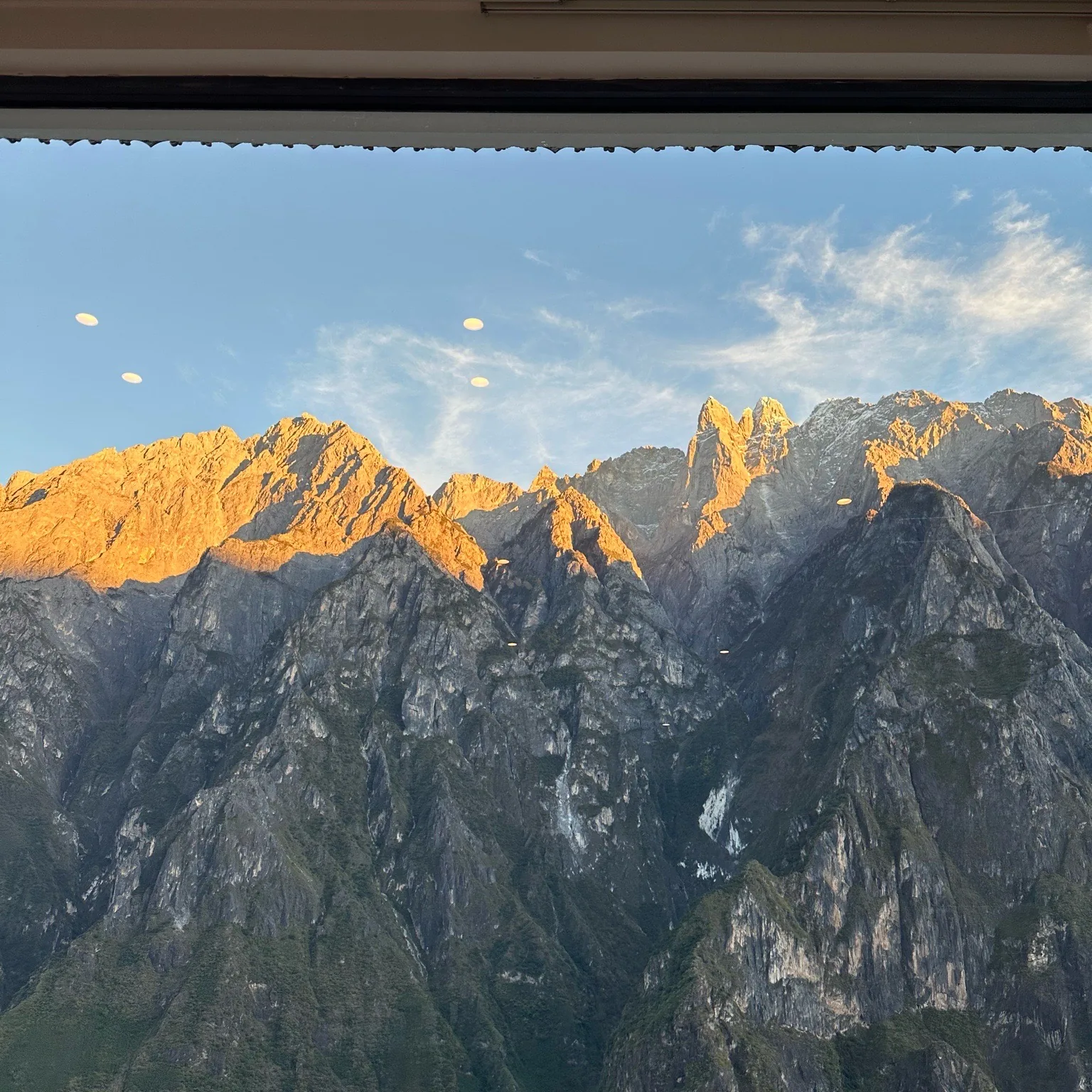 Sunset light on the snow peaks across Tiger Leaping Gorge, seen from Bendiwan
