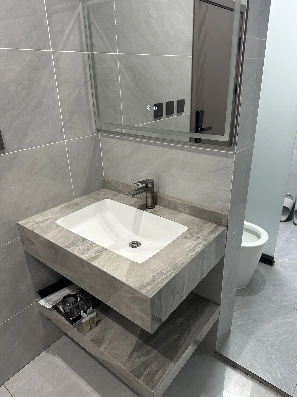 Bathroom sink and mirror at Cloud Way Homestay