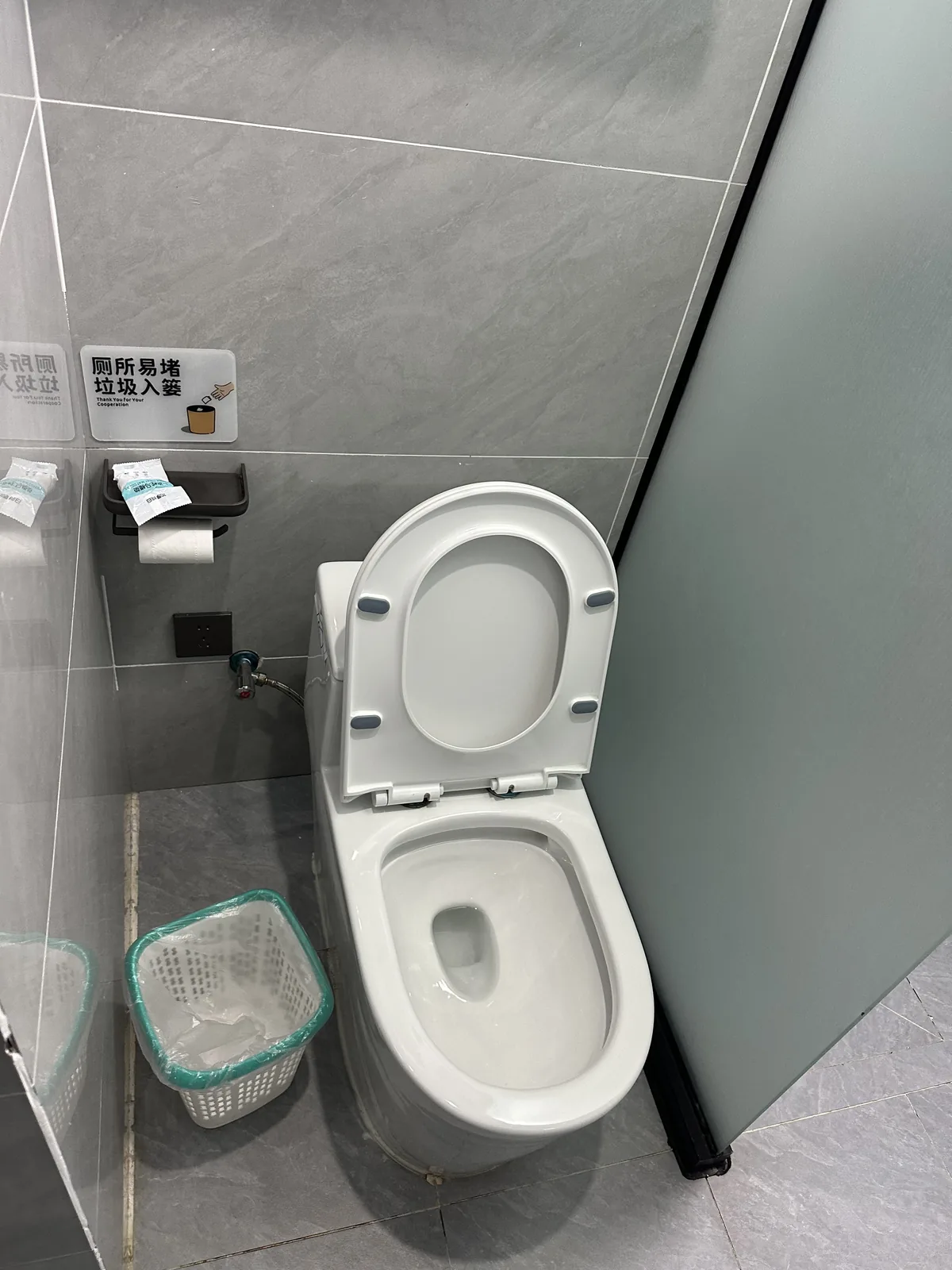 Bathroom toilet and tiled floor, which gets slippery when wet